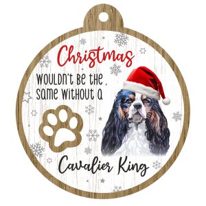 An image of a wooden christmas tree decoration with the wording - Christmas wouldn't be the same without a Cavalier King. There is a picture of the animal.