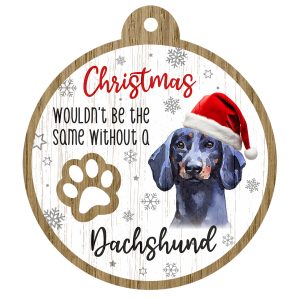 An image of a wooden christmas tree decoration with the wording - Christmas wouldn't be the same without a Dachshund. There is a picture of the animal.