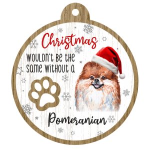 An image of a wooden christmas tree decoration with the wording - Christmas wouldn't be the same without a Pomeranian. There is a picture of the animal.