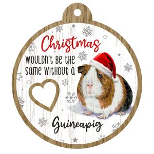An image of a wooden christmas tree decoration with the wording - Christmas wouldn't be the same without a Guinea Pig. There is a picture of the animal.